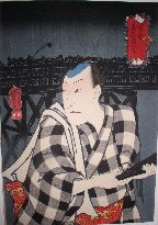 Actor in checkered kimono in front of a bridge